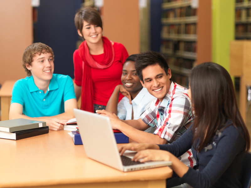 students talking to each other in the library